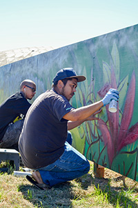 Justin Vasconcellos (front) and Wendell Tabangcura (back) work together on completing the last details of the mural.