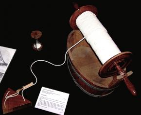 <p><strong>Fig. 8.18. </strong>A chip log, consisting of a weighted board and spool of rope, is used with an hourglass to estimate a ship’s speed.</p>

