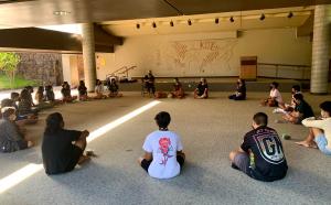 Students practice cultural protocol at Hawaiʻinuiākea on the Mānoa campus.