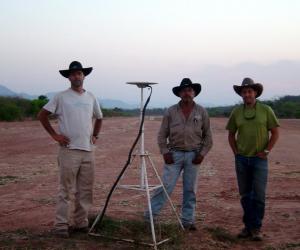Ben Brooks, ‘O. Ozcacha and Todd Ericksen stand next to one of the GPS stations used in the study.