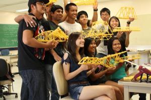 Students posing with their spaghetti bridges.