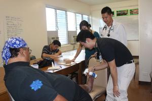 UH medical students helping a patient in Kalaeloa this year.