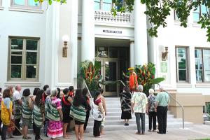 A blessing preceded the untying of the maile lei at the entrance to Gartley Hall.
