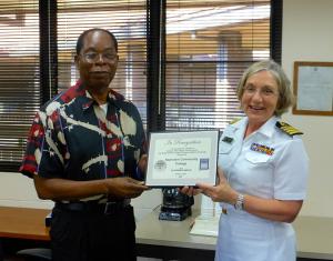 Dr. Betsy Thompson presents Chancellor Leon Richards with Platinum Award.