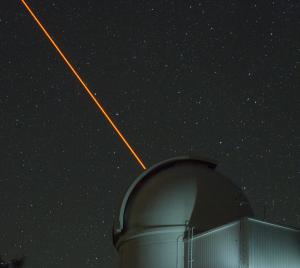The ultraviolet Robo-AO laser originating from the Palomar 1.5-meter telescope dome.