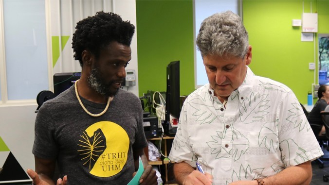 Assistant Professor Keith Cross of the College of Education and Interim Mānoa Chancellor David Lassner share stories at the launch of Truth, Racial Healing and Transformation.