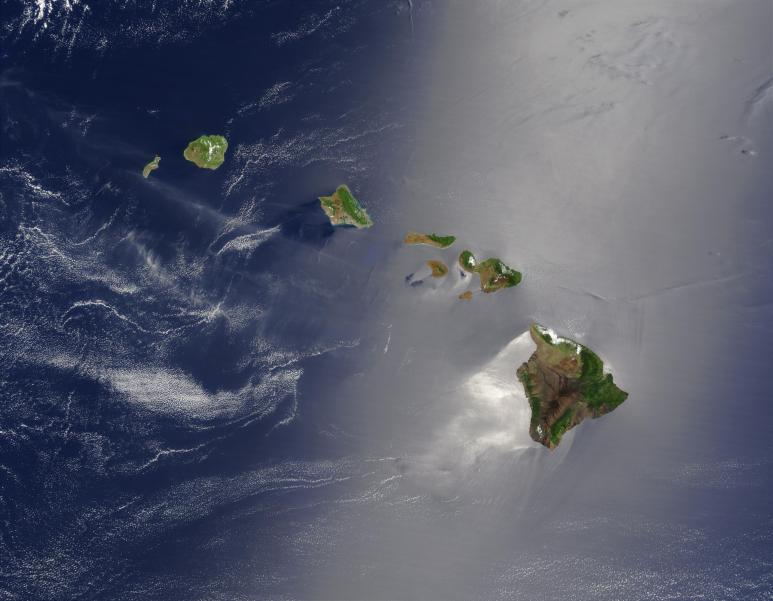 <p>Fig. 1. The Hawaiian Islands as seen from space on May 27, 2003. Notice that the East-facing (windward) sides of the islands are green. The West-facing (leeward) sides of the islands are more brown and dry.</p>

