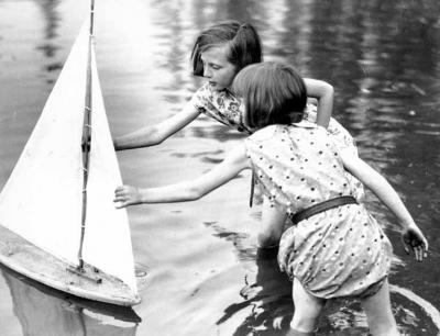 <p>Fig. 2. This image shows two girls playing with a toy sailboat in Seattle, Washington around the 1930's.</p>