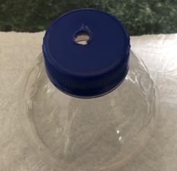 <p>Fig. 3. A small drill bit was used to make a hole in the top of the bottle cap.</p>