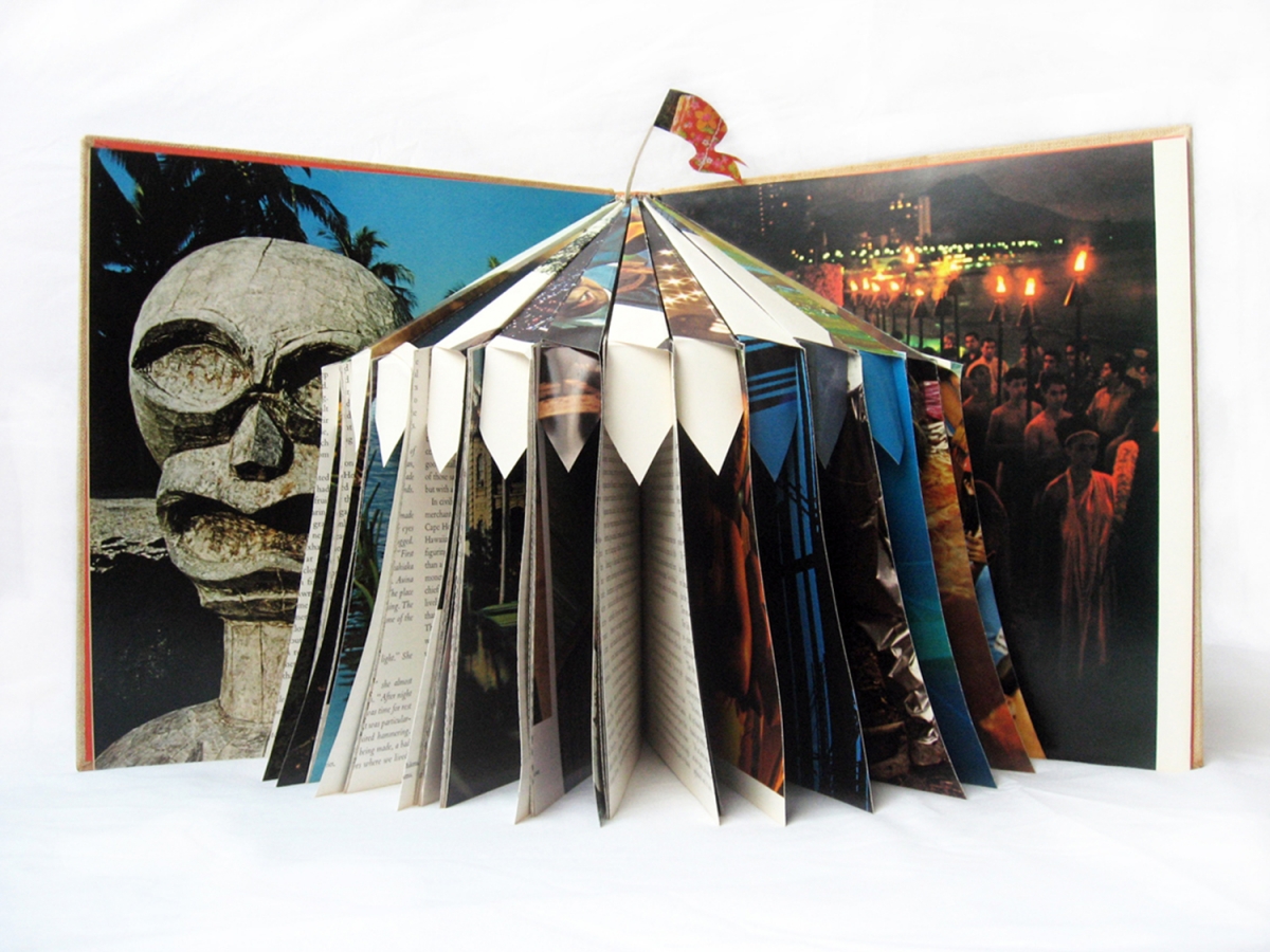 Image shows a photo of an art installation by TCP 30-1 featured artist Maika'i Tubbs. The image is a small circus tent, which has been made out of the folded and cut pages of a book