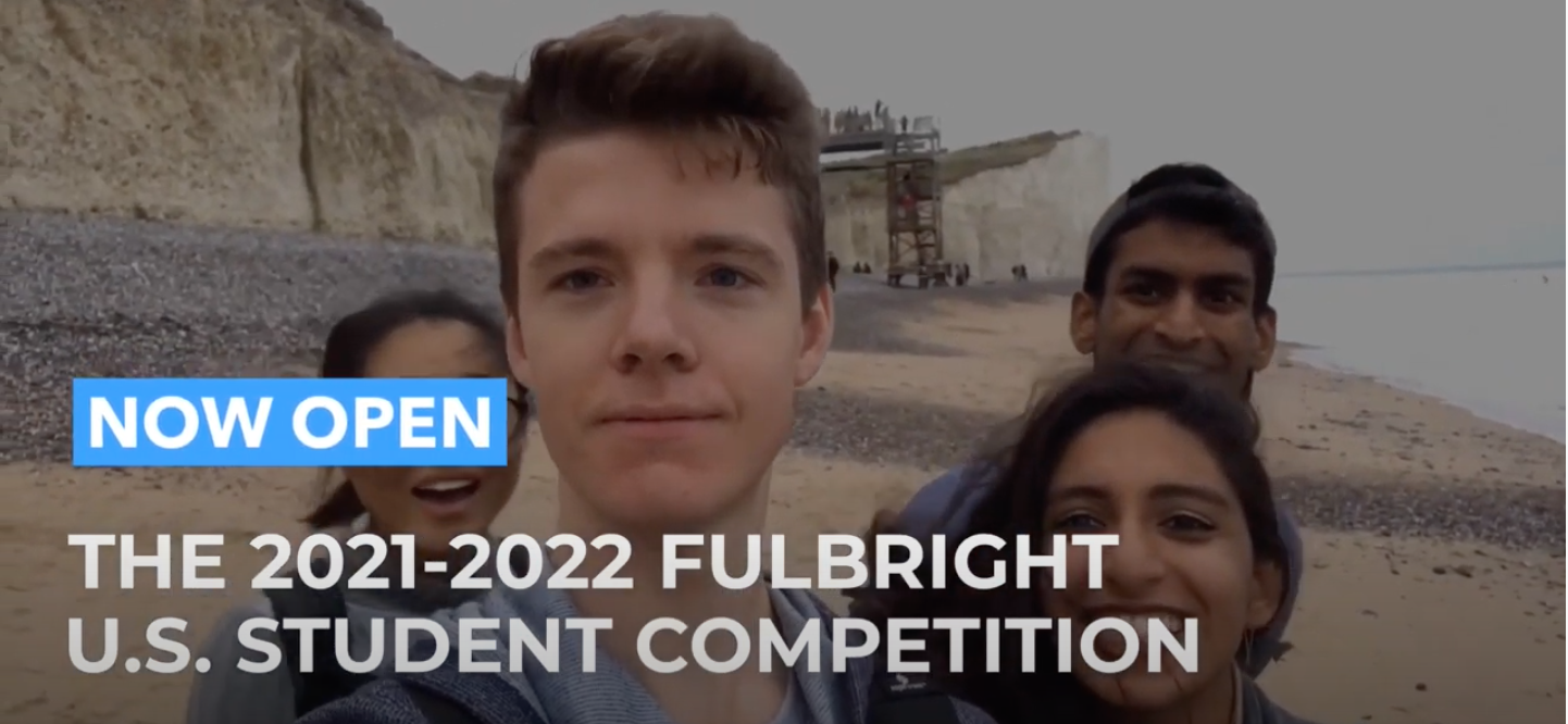 US Fulbright student with international colleagues with white text "2021-2022 Fulbright U.S. Student Competition" in white capital letters.