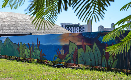 Scenic mural on the roof of the lower campus parking structure with Stan Sheriff Center in background