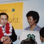 Helene Zeug accepting from Hawaii 4-H alum, Ellison Onizuka, a 4-H flag that flew in Earth’s orbit on the Space Shuttle Discovery in January of 1985.