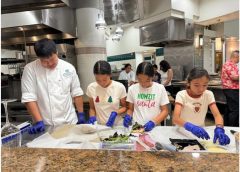 Malama Dolphin 4-H club youth members working under chef guidance in the kitchen