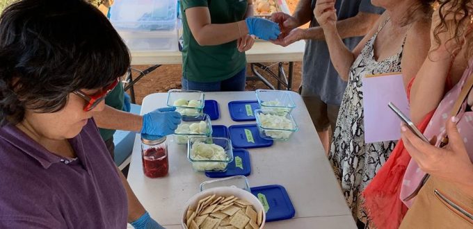 Participants try samples of onion varieties under the tent