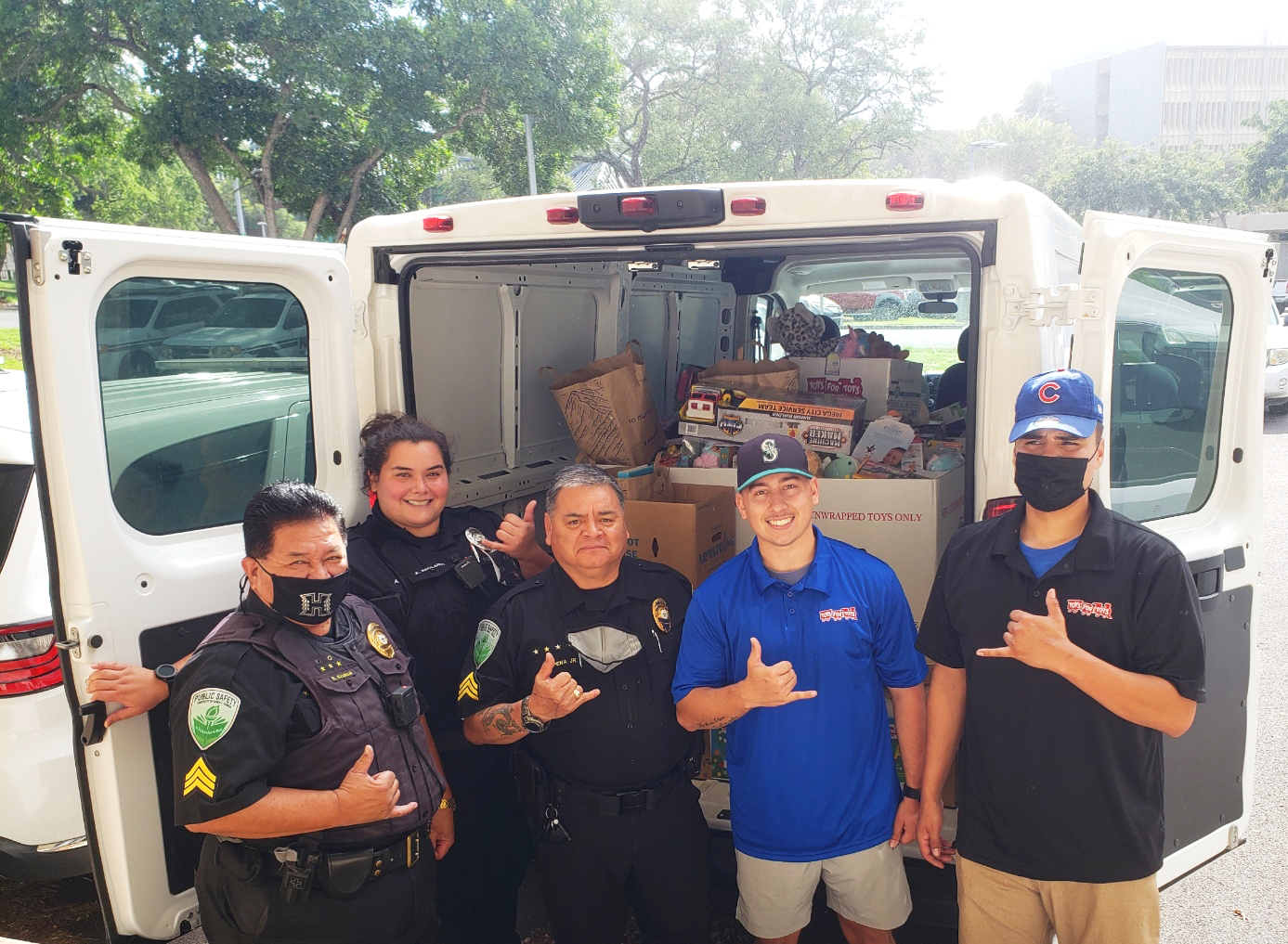 DPS officers load the donation truck with Toys for Tots volunteers