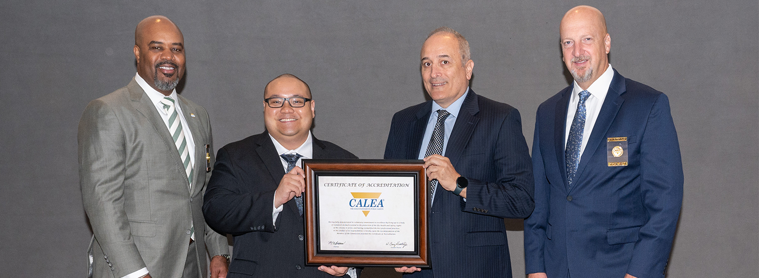 Photo of Chief Black and Jacob Choe receiving CALEA re-accreditation certificate