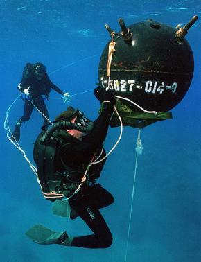 <p><strong>Fig. 9.28.</strong> A US Navy diver wearing a rebreather system practices defusing an underwater mine.</p>