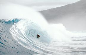<p><strong>SF Fig 4.6.1.</strong> A crouching surfer on a breaking wave in Mexico, illustrating why it can be difficult to agree on wave size</p>