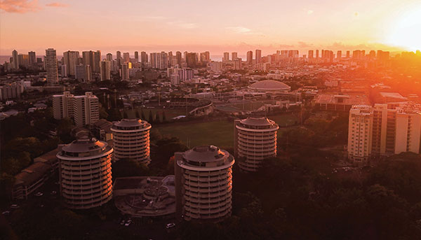 an aerial picture of University of Hawaii Manoa student housings at sunset