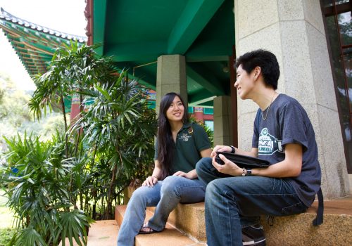 Students Sitting On Steps Of Korean Studies Building