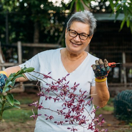 Native Hawaiian woman holding orchids and clippers