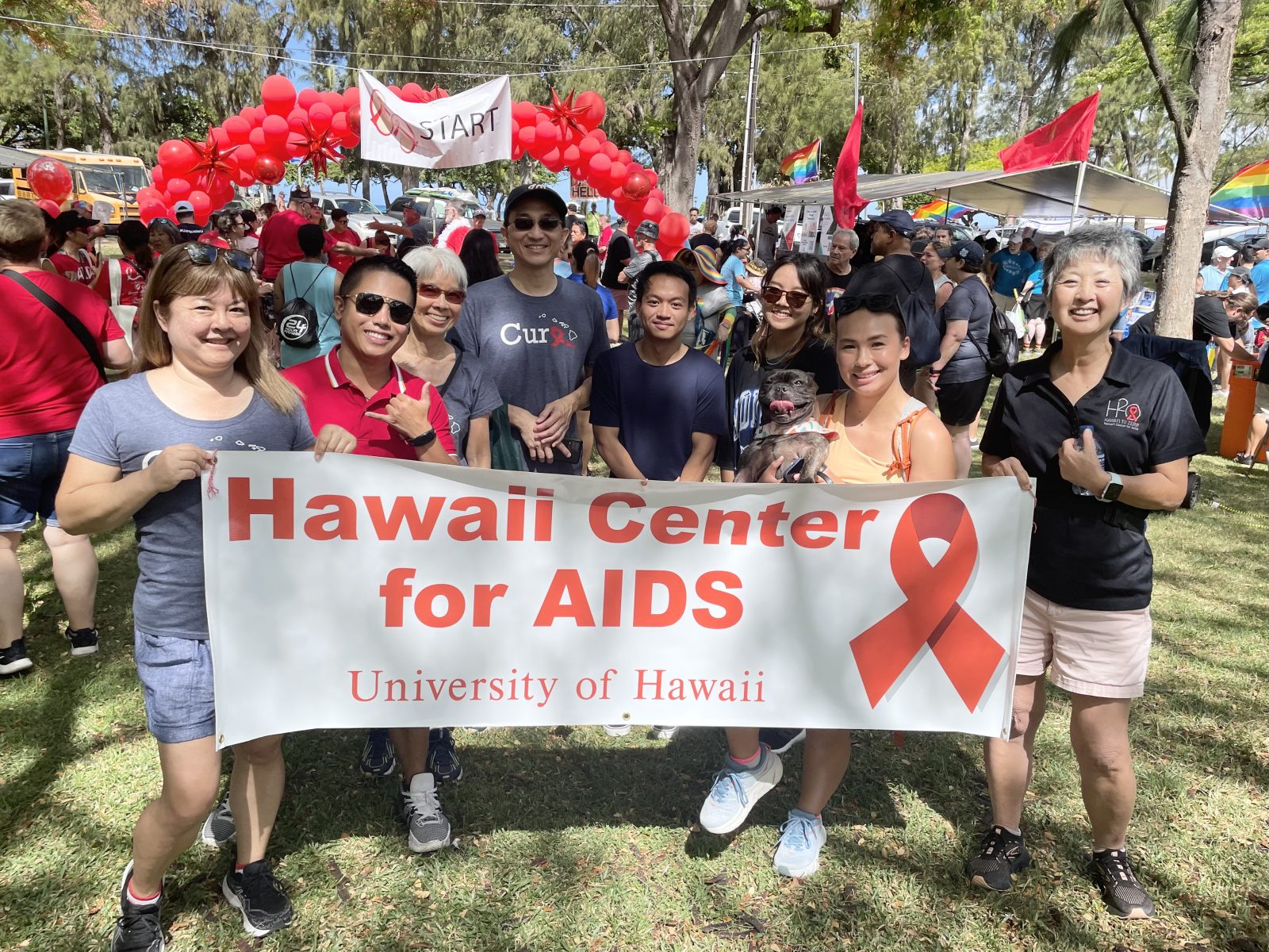 Hawaii Center for AIDS staff at Honolulu AIDS Walk behind Hawaii Center for AIDS Sign