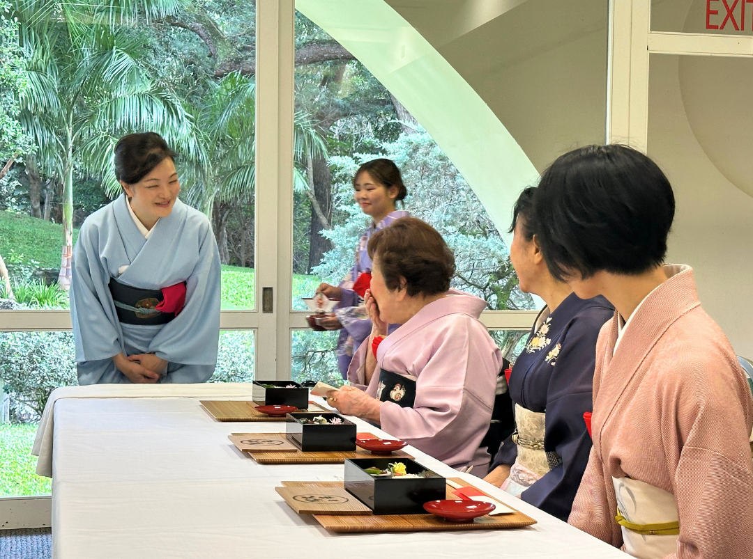 Akiko-sensei in pale blue kimono greeting to the guests.