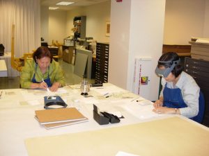 Two workers working on a table.