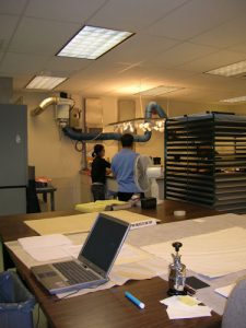 Two workers cleaning maps