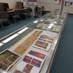 Books in display cases for Painting in Asia exhibit