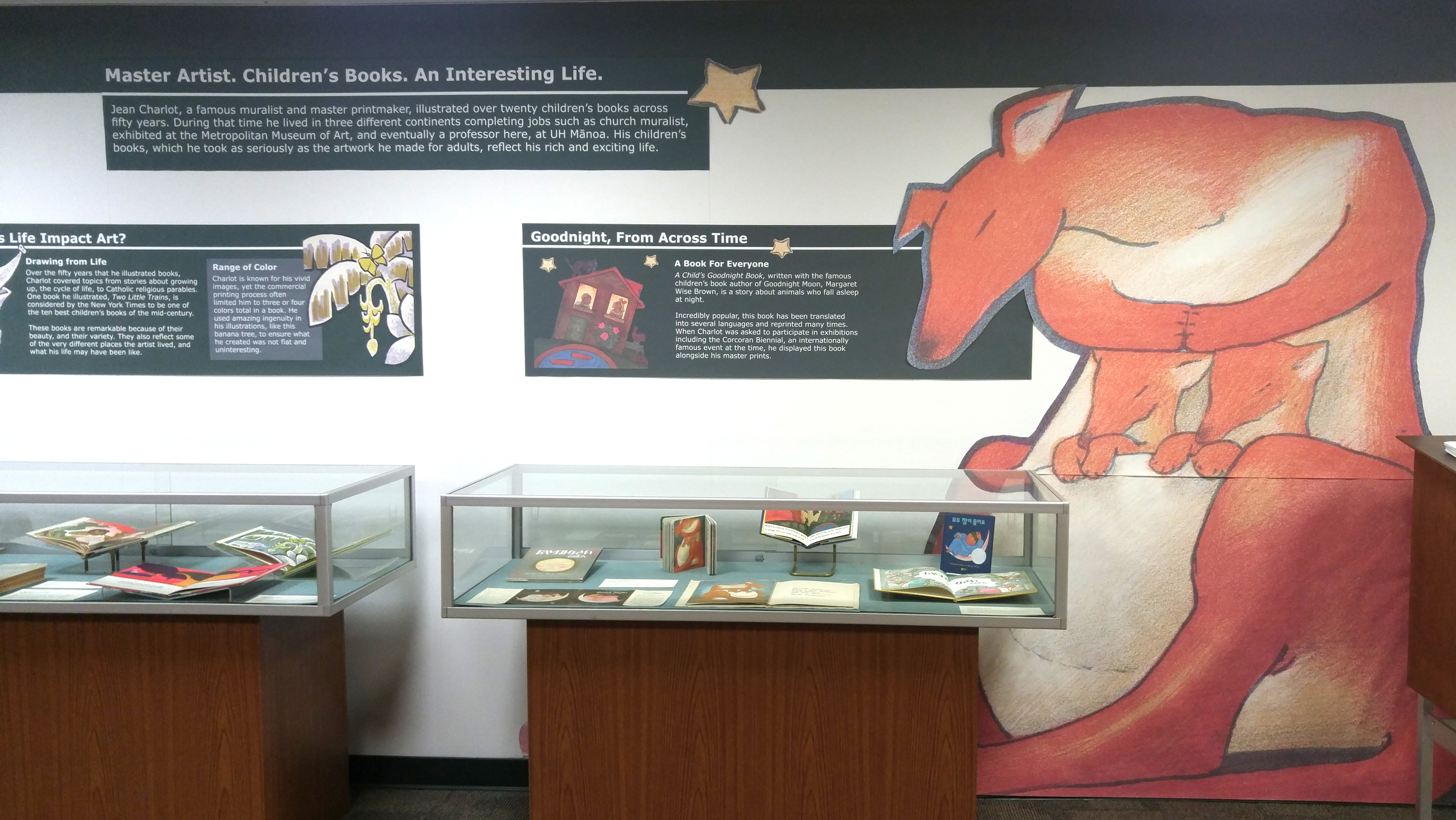 A wall illustration of a kangaroo flanking the Jean Charlot's Children's Book display