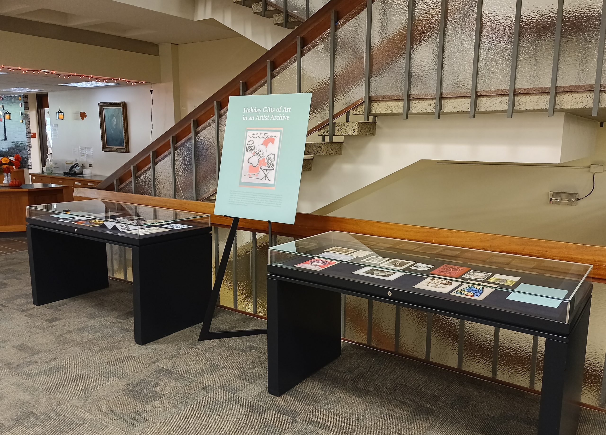 Holiday Gifts of Art Exhibit Poster and display cases