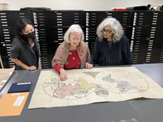 L-R Karen Kadohiro Lauer, Patricia Polansky & Monica Ghosh view the castaway  map