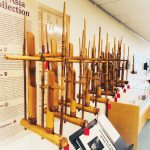 wooden instruments along the wall for the sounding the earth exhibit