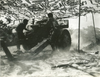 Soldiers firing 105 mm howitzer