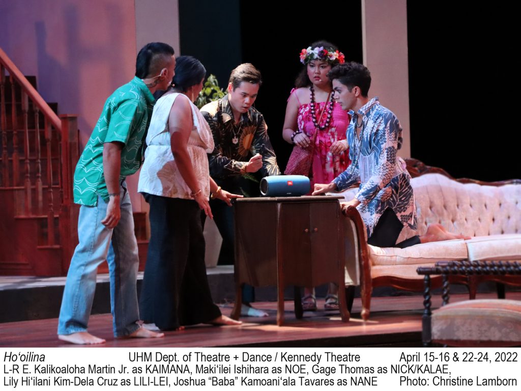 5 college actors gather around a small speaker. Eyebrows are raised. TEXT: Ho‘oilina. UHM Dept. of Theatre + Dance / Kennedy Theatre. April 15-16 & 22-24, 2022 L-R E. Kalikoaloha Martin Jr. as KAIMANA, Makiʻilei Ishihara as NOE, Gage Thomas as NICK/KALAE,   Lily Hiʻilani Kim-Dela Cruz as LILI-LEI, Joshua “Baba” Kamoaniʻala Tavares as NANE. Photo: Christine Lamborn