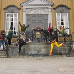Photo from Norway conference features people in different poses in front of an official building