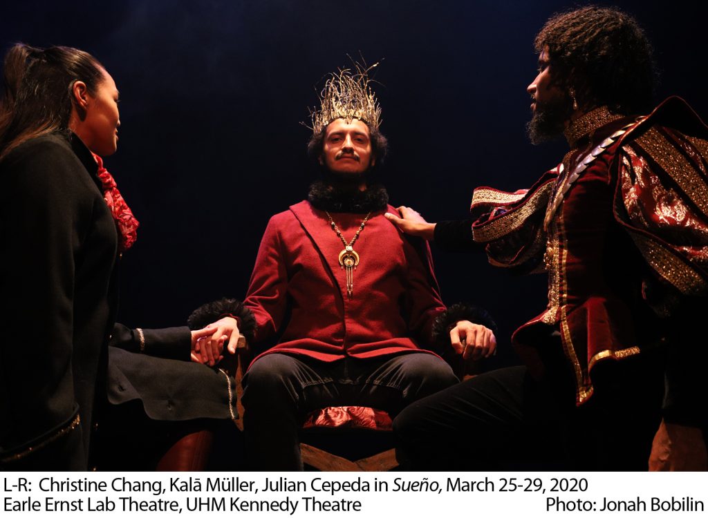 L-R: Christine Chang, Kala Muller, Julian Cepeda in "Sueno" March 25-29, 2020, Earle Ernst Lab Theatre, UHM Kennedy Theatre. Photo: Jonah Bobilin. Actress and actor kneeling before seated 3rd actor in crown. Actress holds crowned figure's right hand, actor has hand of crowned figure's left shoulder. The kneeling actors look at the crowned actor, who looks at the camera.