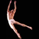 Dancer leaping into air with outstretched limbs
