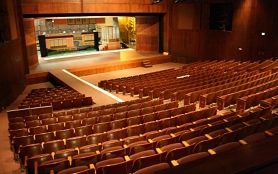 Photo of Kennedy Theatre auditorium and stage with a set in the background
