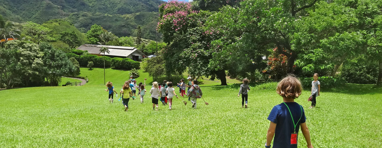 Children running across a lawn