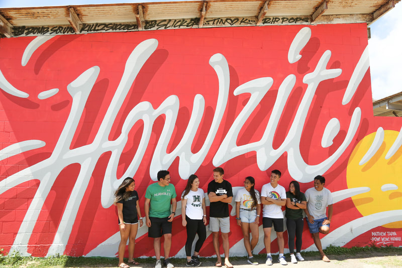 group of Rainbow Warriors in front of mural