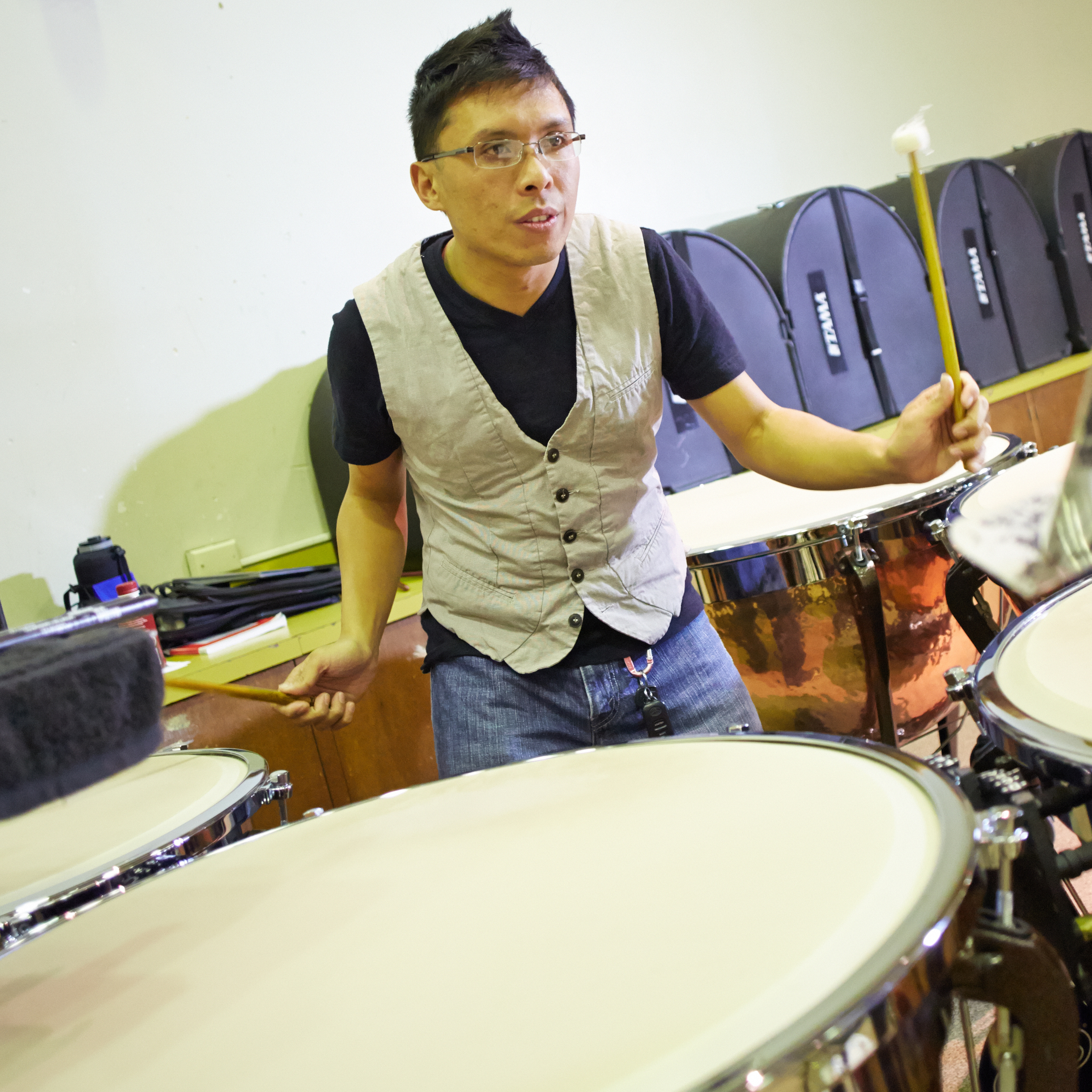 Student Frederick Mariano playing timpani during a Wind Ensemble rehearsal.