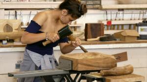 Castle High School student Haley Texeira works on a papa kuʻi ʻai (poi pounding board).