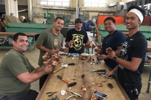 Sheet metal students handcrafting each copper rose