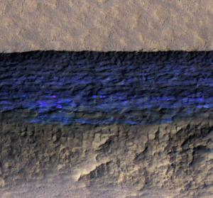 Ice (blue) below the surface at a scarp near Hellas Planitia on Mars. Credit: NASA/JPL/Univ of Ariz