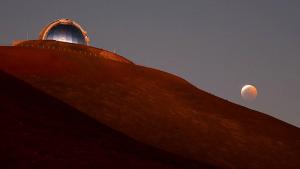 NASA Infrared Telescope Facility telescope on Maunakea during a lunar eclipse.