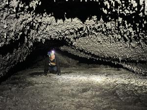 Assistant Professor Rebecca Chong explores lava tube caves on Hawai‘i Island. (Credit: Megan Porter)