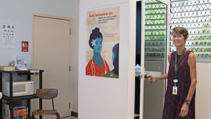     Deborah Matthews displays a poster at Castle High School's health clinic.
